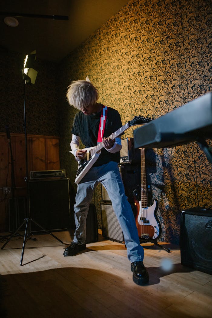 Man in Black Shirt Playing Guitar